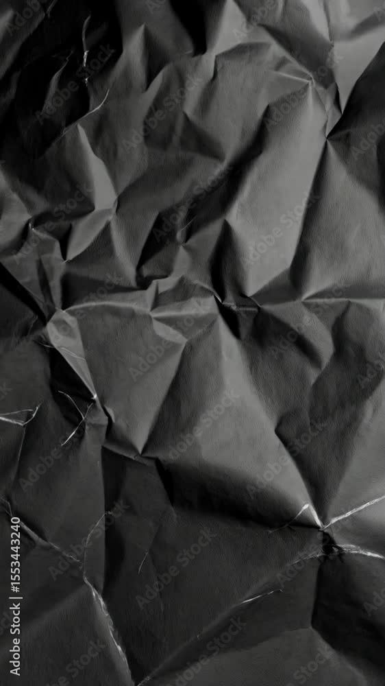 Poster monochrome crumpled paper texture with high contrast shadows and detailed wrinkle formations in a cl