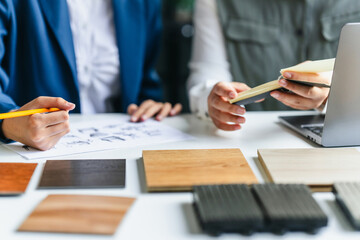 Consultant reviewing wood laminate samples for interior project