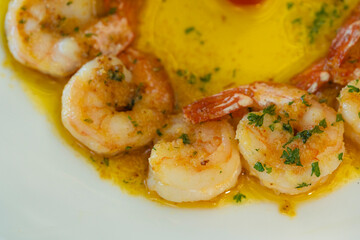 Close-up of shrimp in garlic butter sauce with parsley