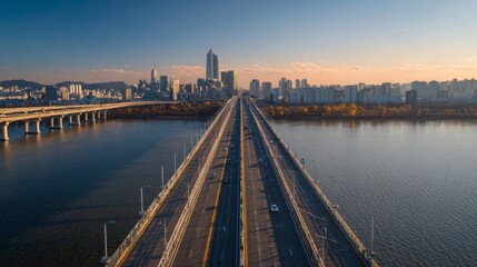 A high-resolution photo of a modern expressway bridge over a river, with vehicles crossing and the city skyline visible in the distance.
