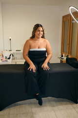 Model preparing for a photoshoot in a stylish studio setting