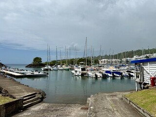 view of sailboats in a small marina in Guadeloupe on a cloudy day
