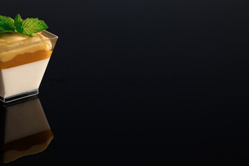 Panna cotta tropic vanilla panna cotta, mango, mango-passion fruit mousse. Glass with chocolate...