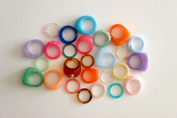 Collection of colorful plastic rings on white background. Top view.