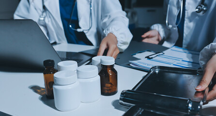 Male and female doctors are having a meeting in a hospital room.