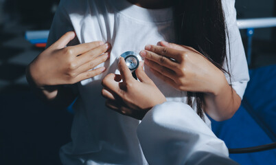 Cropped image of male doctor's hand using stethoscope to examining heartbeat and symptom of patient...