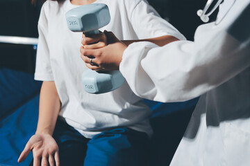 Unrecognizable uses blue hand weight during physical therapy session