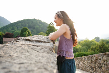 Young woman with black ostomy bag in nature