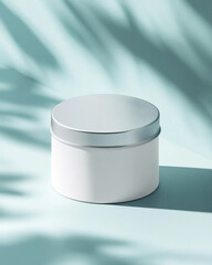 Small white round tin container with sleek silver lid, minimalist product mockup on smooth pale blue background