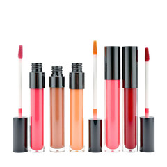 Obraz premium A selection of six lip gloss tubes in different colors displayed against a plain background.