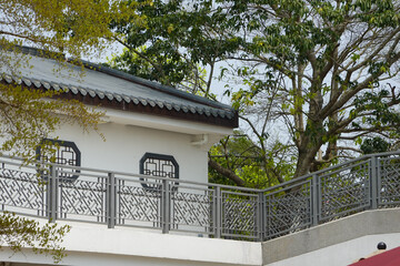 Ornamental Pavilion with Lattice Railing Beside Garden Trees
