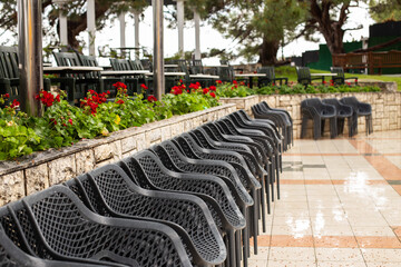 Empty chairs and tables in outdoor restaurant setting waiting for customers