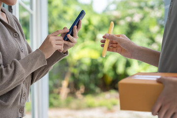 Happy smile Asian woman scan QR code for pay of food. Delivery man send deliver express. online...