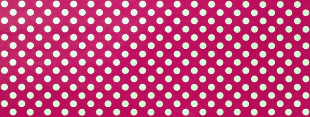 Dark red background from wrapping paper with white polka dot pattern. Texture of purple dotted paper backdrop