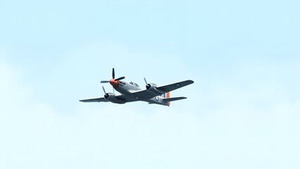 Grey Orange Twin Engine Airplane isolated on a transparent background