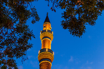 View of the İplikçi Mosque (Camii) Minaret during blue hour.