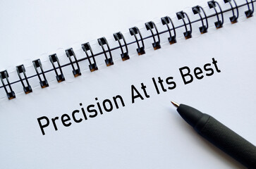 Precision At Its Best on notebook with black pen for concept of accuracy and performance