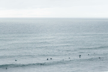 Surfers Riding Waves Along the Portuguese Coastline