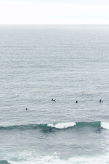 Surfers Riding Waves Along the Portuguese Coastline