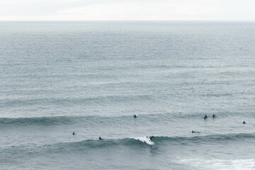 Surfers Riding Waves Along the Portuguese Coastline