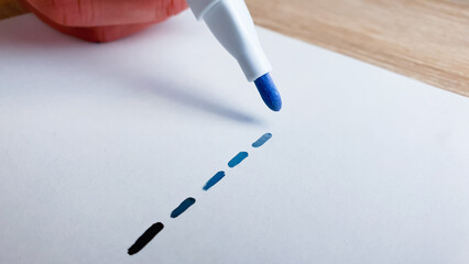 Draw dotted lines, lines, shades of gray, dark shades on a white sheet of paper with a marker.