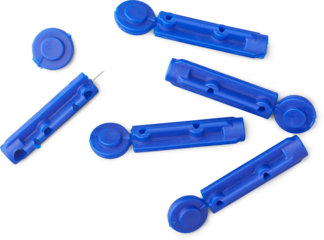 close-up of disposable blood sugar testing lancets with protective cap isolated white background, sterile medical devices taken from above, diabetes management or home blood testing concept