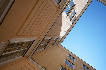 Obraz premium Old yellow building. Clear blue sky. Windows detail. Urban architecture. 
