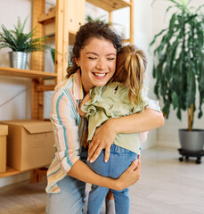 Portrait of mother and daughter  having fun, running and hugging  at home, family life, parenting,...