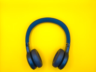 Dark green big headphones on a plain bright yellow background for banners, for advertising. copy space. High quality photo