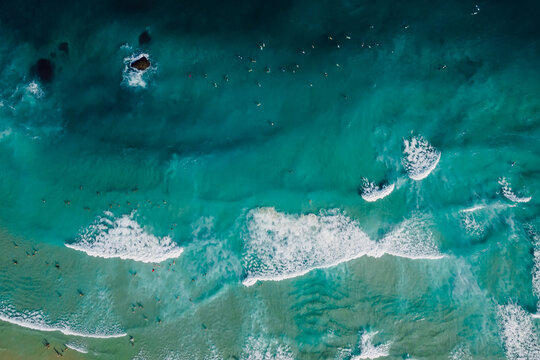 Top down view of blue ocean with crashing waves, drone shot - Powered by Adobe