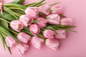 Obraz premium Bouquet of pink delicate tulips on pink background, Top view