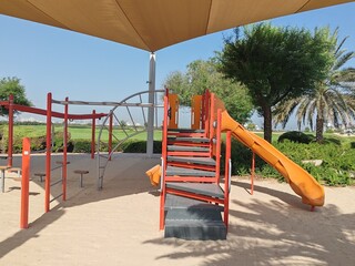 Kids Playing Area.
Colorful kids playground beautiful garden children amenity area in community society. 
Children Swings, Kids sliding, Playing Yard
Adult play activities in public Safe Sport Park.