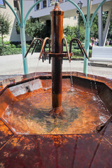 Old mineral water fountain in Sopot, Czech Republic, with multiple spouts and orange mineral...