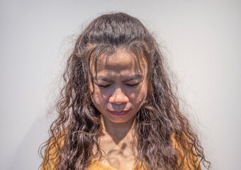 Portrait of an Asian woman with long curly hair