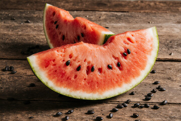 Juicy watermelon slices on rustic board.