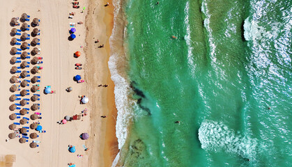 Aerial view of Dehesa de Campoamor beach on Costa Blanca. Straw umbrellas, sandy shoreline,...