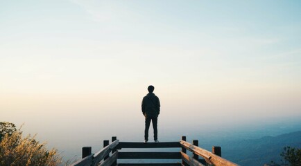 Man looks at a landscape from the top of the observation point