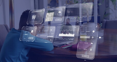 Interacting senior man using digital dashboards on laptop in home workspace, with child and pencils