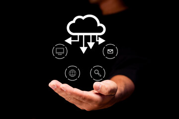 A person holds a digital representation of cloud computing with icons for devices, email, internet,...
