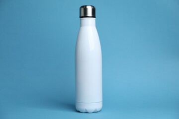 One white water bottle on light blue background