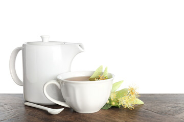 Tasty linden tea in cup, teapot, leaves and flowers on wooden table against white background