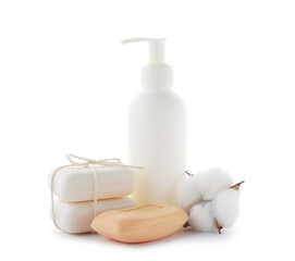 Soap bars, bottle of skincare product and cotton flower isolated on white