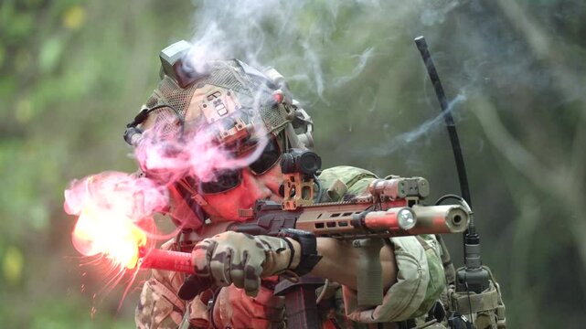 A special forces soldier holds a burning red signal flare during a jungle operation A dramatic close up concept for survival emergency signals and rescue missions