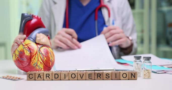A medical professional explains cardioversion using a heart model and discusses various treatment options