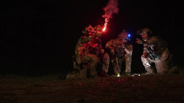 Special forces team gathers at night for a mission briefing, equipped with night vision goggles and tactical gear, ready for a stealth operation under darkness.
