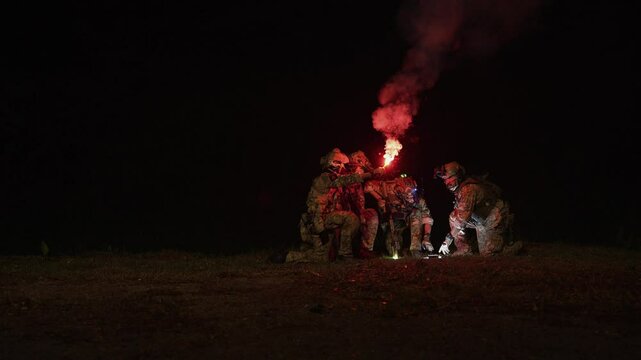 Special forces team gathers at night for a mission briefing, equipped with night vision goggles and tactical gear, ready for a stealth operation under darkness.