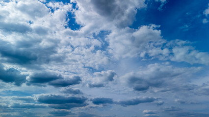 Dramatic cloudscape showcasing a variety of cloud types in a deep blue sky. Perfect for illustrating weather concepts or nature themes in publications.