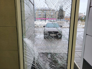 There is broken glass in the front door of the store