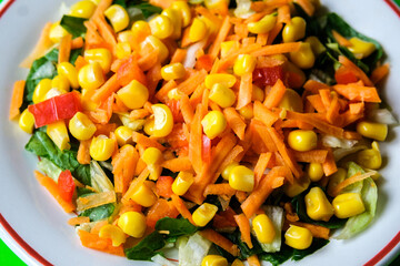 Fresh Refreshiung Summer Salad Of Sweet Corn Carrots Red Peppers and Leaves