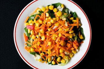 Fresh Refreshiung Summer Salad Of Sweet Corn Carrots Red Peppers and Leaves